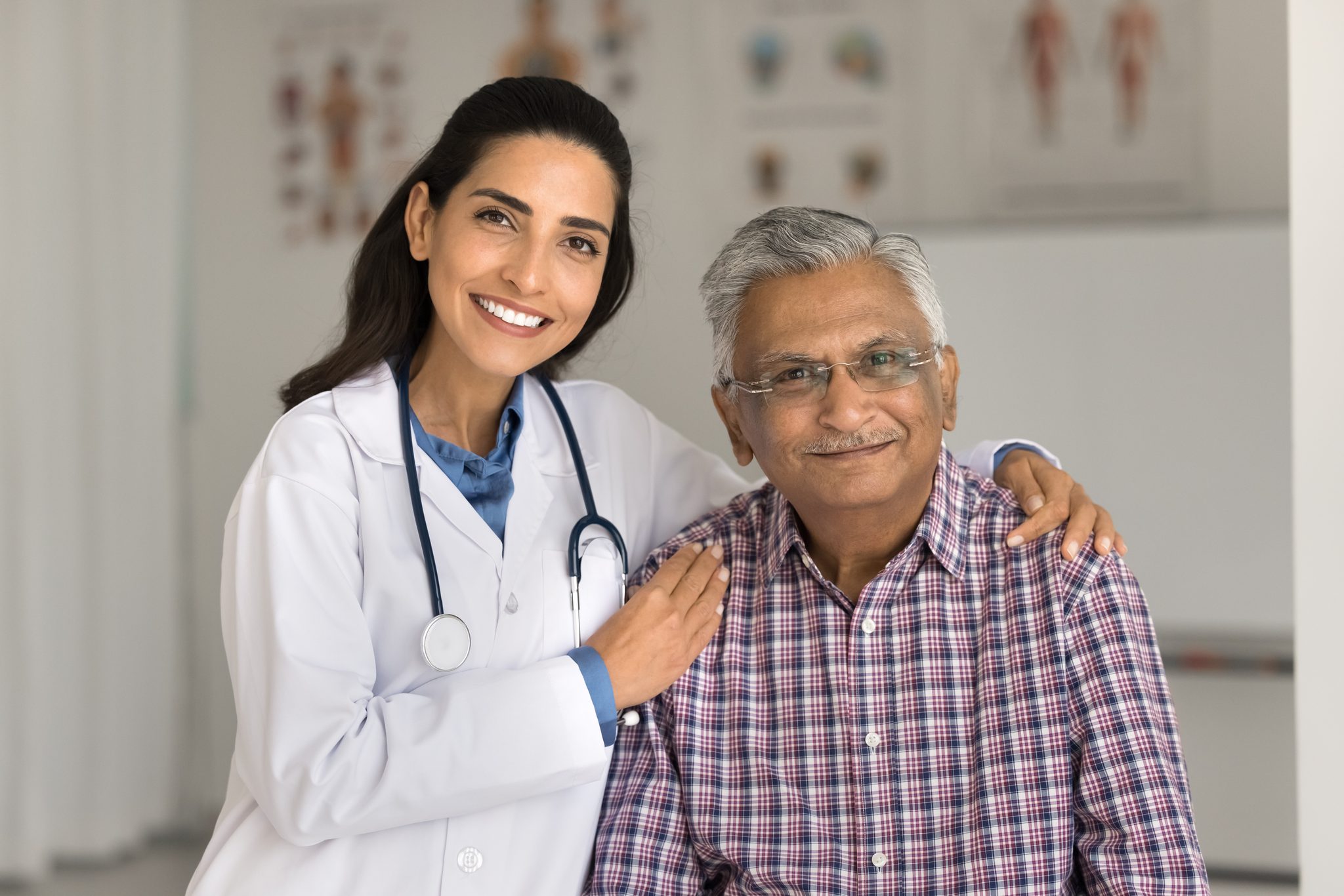Physician reassuring an older patient during a consultation