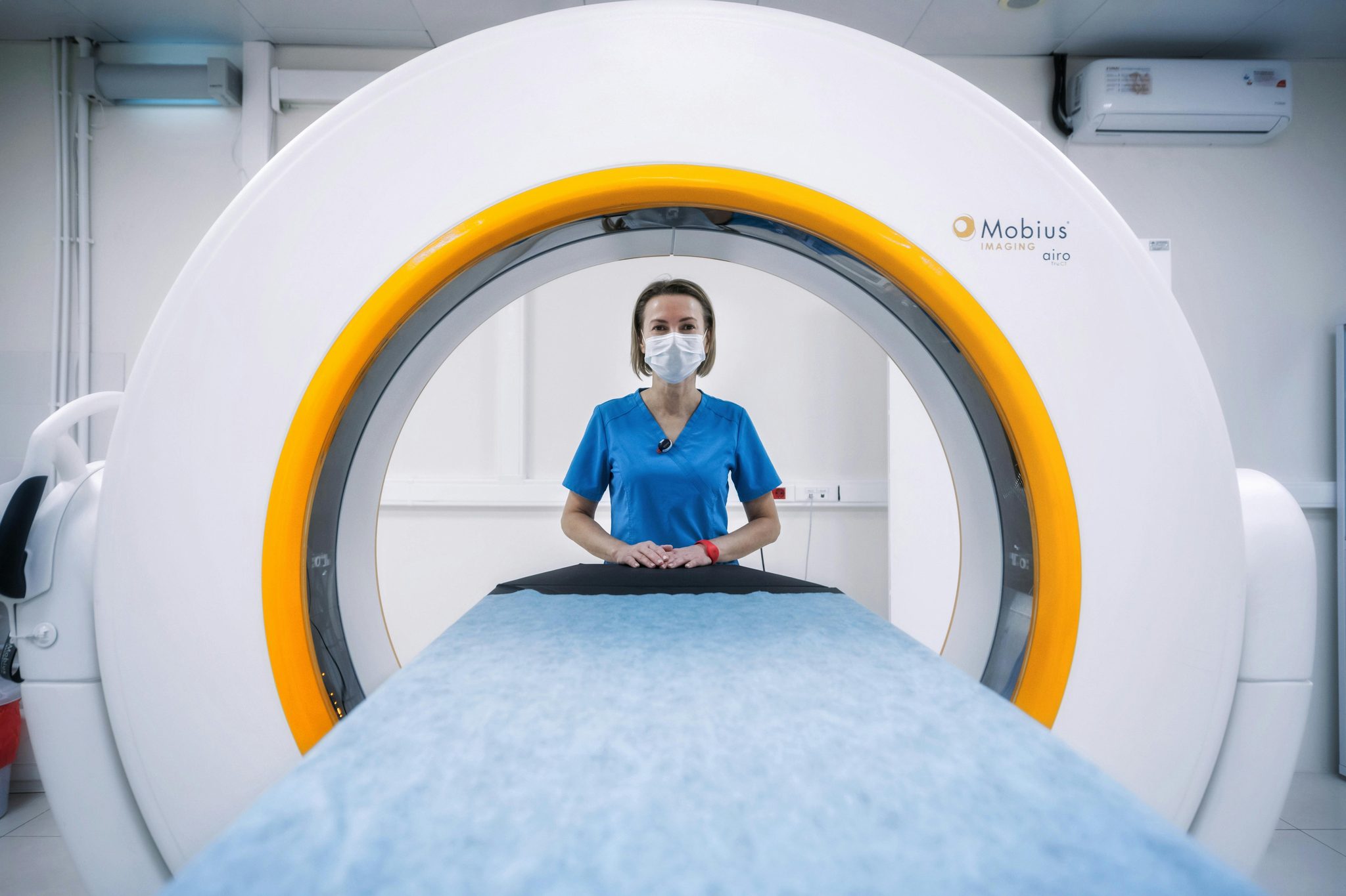 Radiographer preparing a patient for a CT scan